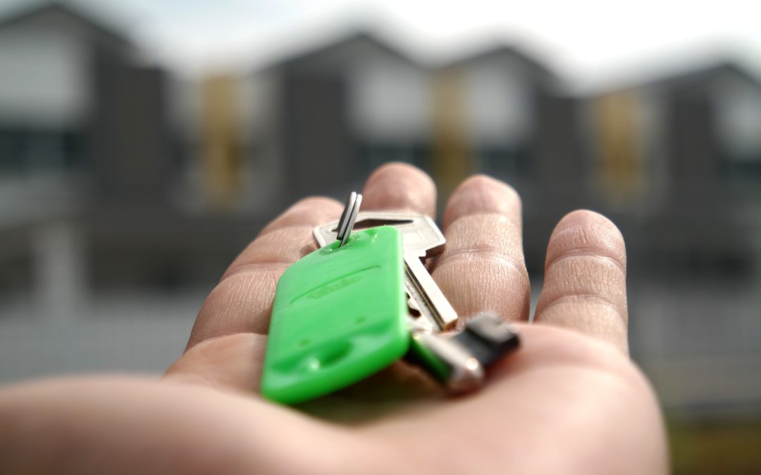 keys in a hand to illustrate residential real estate investment